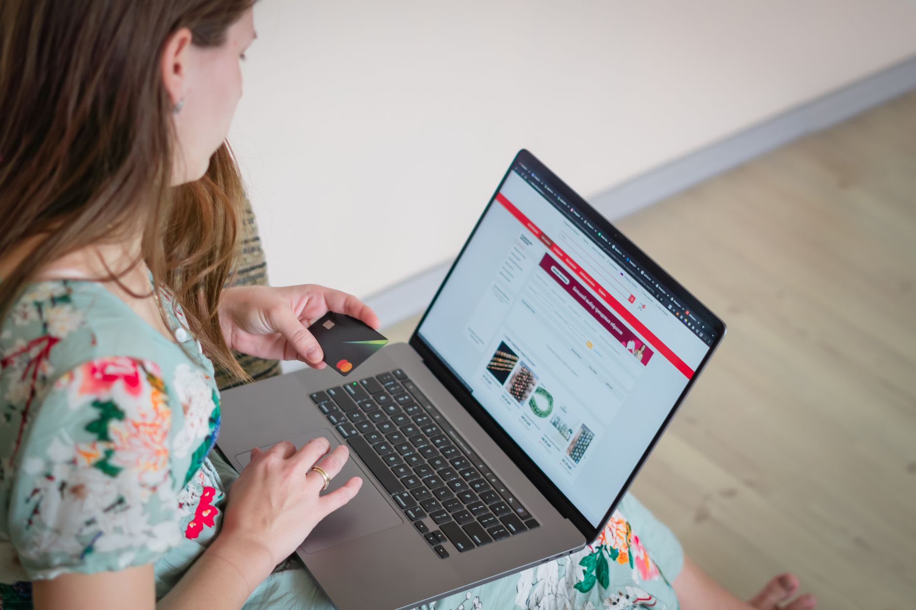 Une cliente installée dans son canapé fait des achats en ligne sur son ordinateur portable